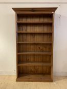 A late 20th century pine floor standing bookcase, the projecting cornice over five fixed shelves,