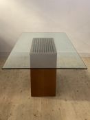 A large contemporary dining table, the glass top raised on a veneered walnut rectangular pedestal
