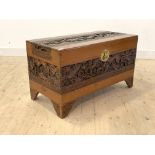 A Mid 20th century Chinese carved camphour wood blanket box with hinged lid and bracket supports,