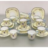 A Paragon china 1920's / 30's, 32-piece tea service with handpainted enamel floral sprays, with blue