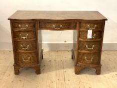 A Georgian style figured walnut serpentine knee hole desk, first half of the 20th century, with