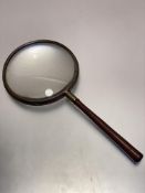 A large late 19thc brass mounted hand magnifying glass, with treen handle, (L 27cm x d 12cm)