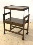 A vintage two tier oak metamorphic drinks trolley, raised on castors, H86cm, W70cm, D38cm