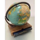 A modern Reader's World Rand McNally Atlas complete with oak stand and terrestrial adjustable