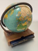 A modern Reader's World Rand McNally Atlas complete with oak stand and terrestrial adjustable