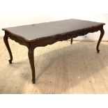 A French style walnut extending dining table, the top of serpentine outline with parquetry top