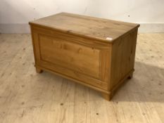 A modern pine blanket box, with hinged lid, panelled front raised on block supports, H48cm, W80cm,