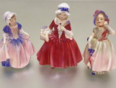 A collection of three Royal Doulton china figures, Dinky Do, HN1678FB, Babie HN1678HF, and Lavinia