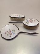 A white metal three-piece guilloche enamelled dressing table set including hand mirror, slight