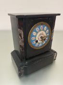 A Victorian black slate and agate mounted mantel clock with French style blue enamelled dial with