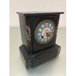 A Victorian black slate and agate mounted mantel clock with French style blue enamelled dial with