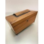 A 19thc walnut sarcophagus shaped tea caddy, the interior fitted with centre open aperture flanked