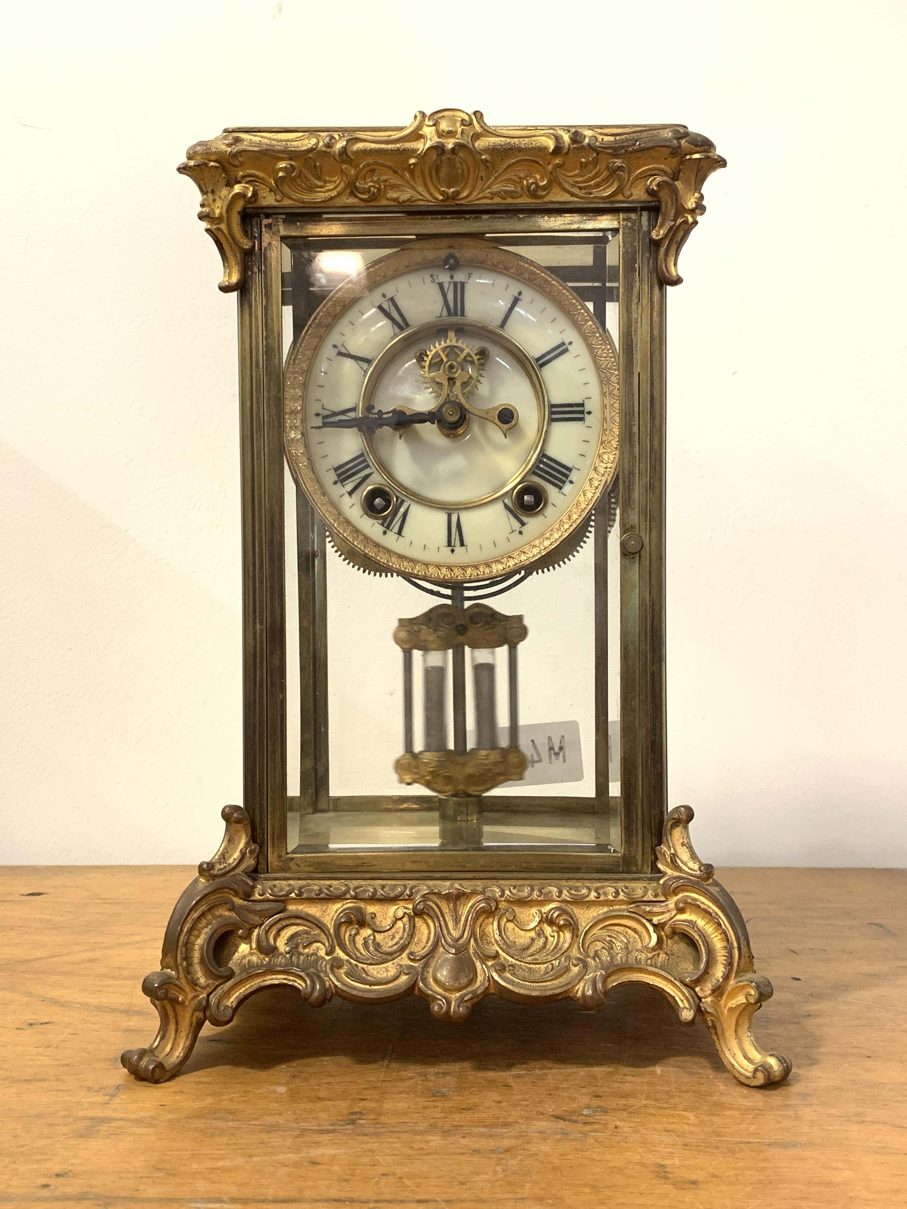 An Early 20th century four glass presentation clock, the cast brass case with 's' scrolls in the