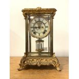 An Early 20th century four glass presentation clock, the cast brass case with 's' scrolls in the