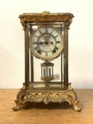 An Early 20th century four glass presentation clock, the cast brass case with 's' scrolls in the