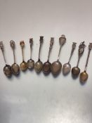 A collection of nine various souvenir tea spoons including Paris, Playe, Nice, Arras, etc some