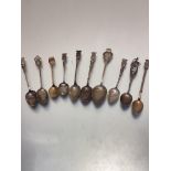 A collection of nine various souvenir tea spoons including Paris, Playe, Nice, Arras, etc some