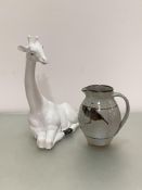 A seated white ceramic Italian novelty giraffe figure (h46cm) and a Kailzean pottery jug decorated