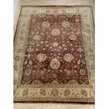 A hand knotted Persian Ziegler design rug, the red field with floral decoration enclosed by an ivory