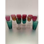 A collection of ten various Edwardian cranberry glass wine glasses, two amber glass cordial glasses,