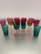 A collection of ten various Edwardian cranberry glass wine glasses, two amber glass cordial glasses,