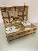 A 1930's pig skin picnic case complete with early plastic cups, saucers, side plates, sandwich