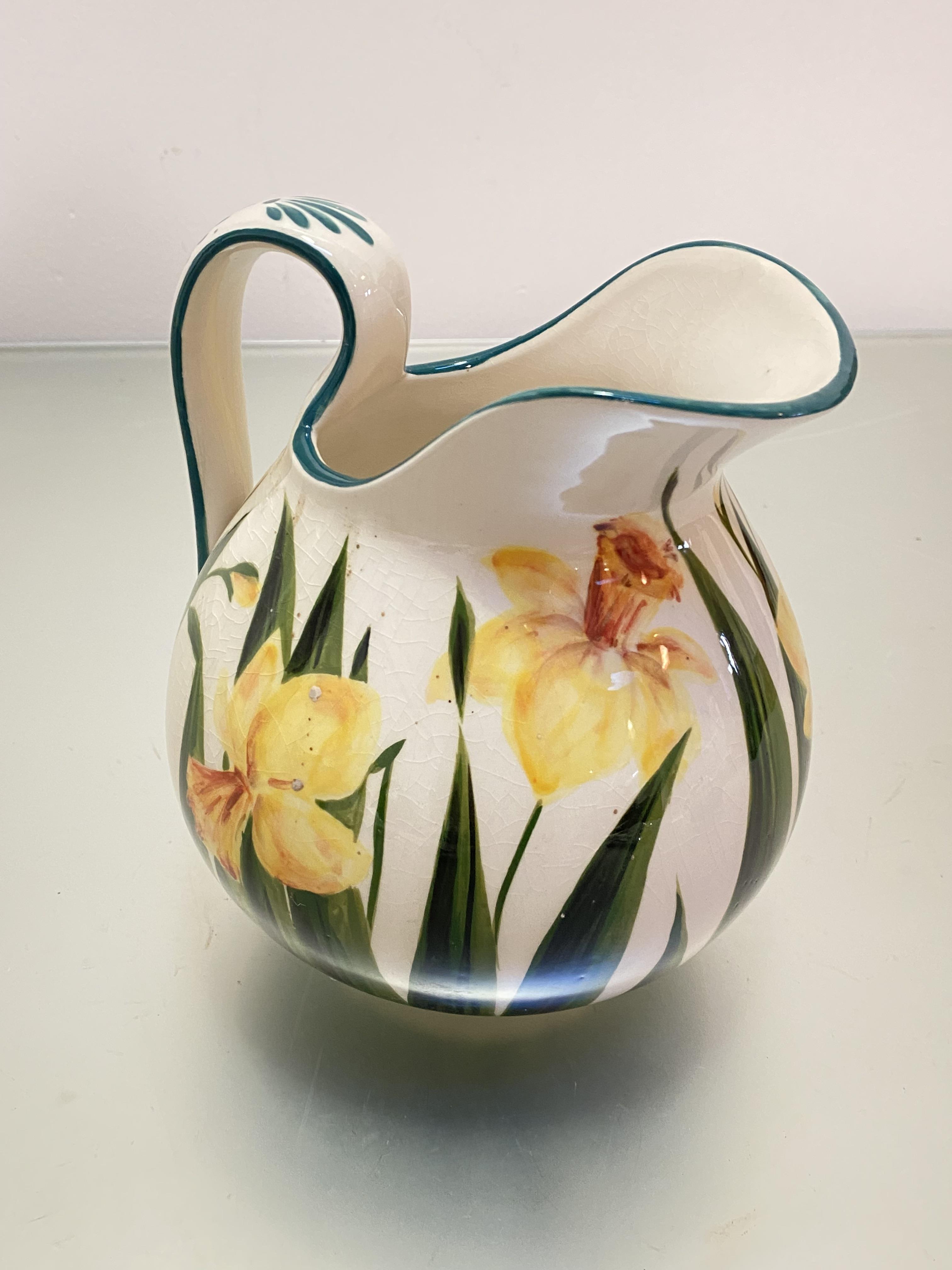 A Griselda Hill Wemyss style pottery ewer decorated with daffodil design, (h 17cm x 18cm x 16cm)