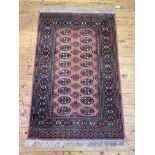 A hand knotted bokhara rug of typical design, W99cm