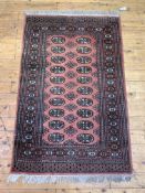 A hand knotted bokhara rug of typical design, W99cm