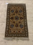 A Persian hand knotted rug, the brown field with birds and foliate framed within a a guarded border