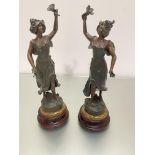 After Buchot, a pair of spelter enamelled female figures, "Paquerette" and "Bouton D'Or", mounted on