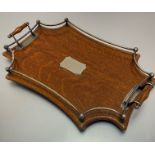 An Edwardian oak two-handled tea tray with Epns gallery with presentation plaque presented to Miss