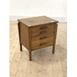 A 1940's walnut sewing chest, fitted with three drawers, two of the drawers having removable trays