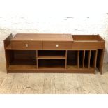 A mid century teak sideboard, the top with two drawers and a well, extending to the left, over