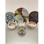 A collection of three Poole Pottery plates decorated with stylised modern designs, (largest d