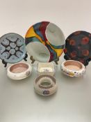 A collection of three Poole Pottery plates decorated with stylised modern designs, (largest d