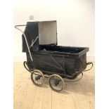 An early 20th century pram, with folding hood and four spoked wheels on leaf spring suspension,