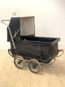 An early 20th century pram, with folding hood and four spoked wheels on leaf spring suspension,