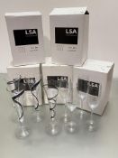 Three boxes of four clear LSA champagne flutes and two boxes of Black Jazz champagne flutes, each