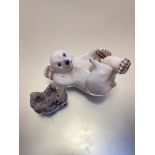 A Royal Copenhagen porcelain figure of a polar bear cub playing on its back, a Royal Copenhagen