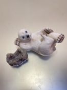 A Royal Copenhagen porcelain figure of a polar bear cub playing on its back, a Royal Copenhagen