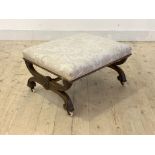 A Victorian walnut framed footstool by John Taylor & sons, Edinburgh, the top upholstered in