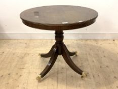 A Regency style mahogany circular centre table, the tilt top raised on turned column and four