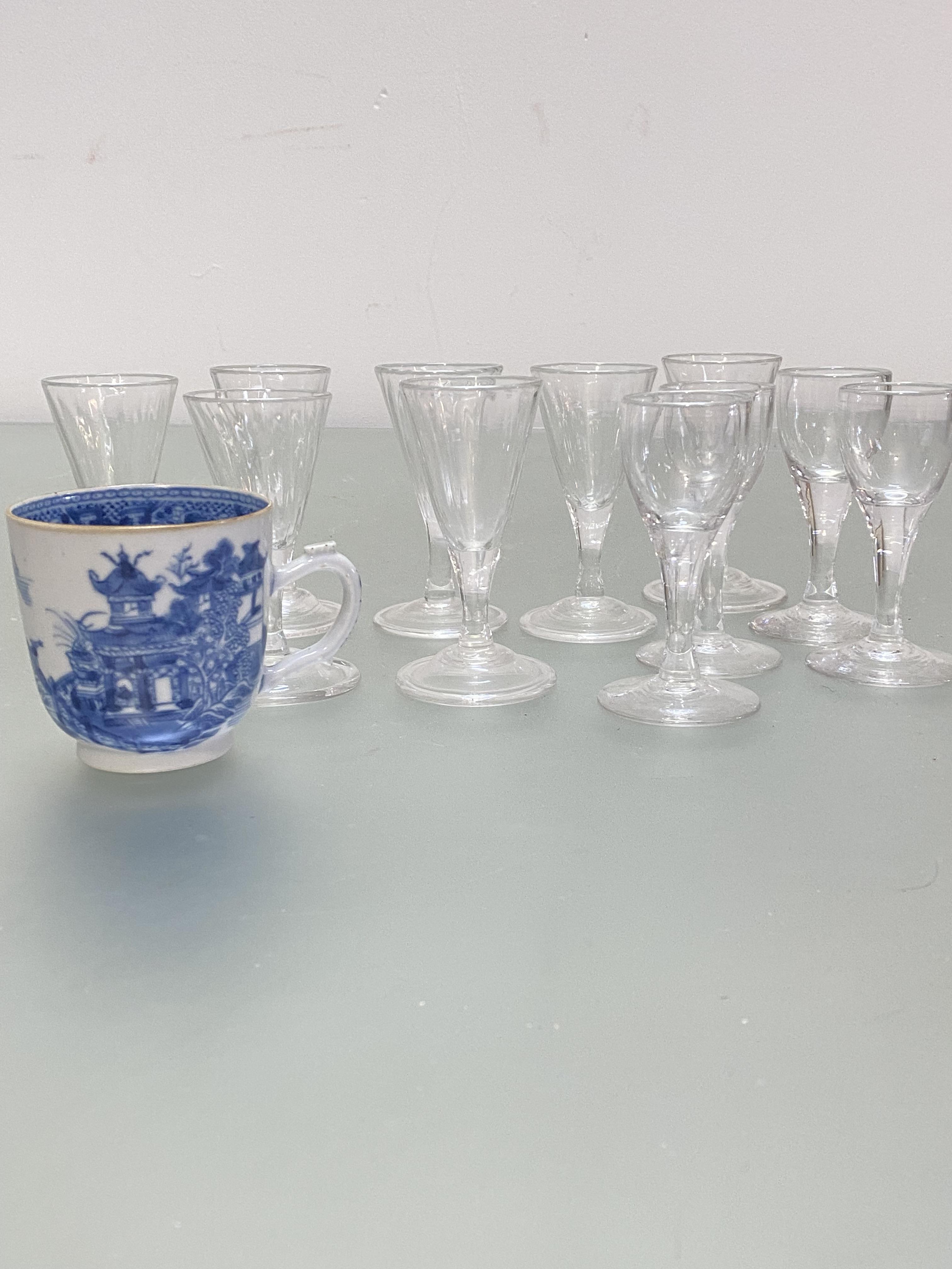 A set of seven Edwardian spiral lobbed cordial glasses with domed folded feet, (h 10cm x d 5cm), and