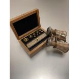A satinwood box containing nine various miniature weights, complete with fittings etc, and a pair of