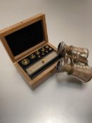 A satinwood box containing nine various miniature weights, complete with fittings etc, and a pair of