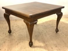 An early 20th century mahogany extending dining table with two leaves, raised on cabriole supports