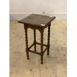 An early 20th century oak lamp table, the square top raised on bobbin turned and block supports,