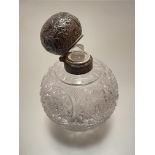 A crystal perfume bottle complete with Birmingham silver mounted hinged top, decorated with leaf and