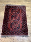 A red ground bokhara rug with three gulls and bordered, 104cm x 150cm